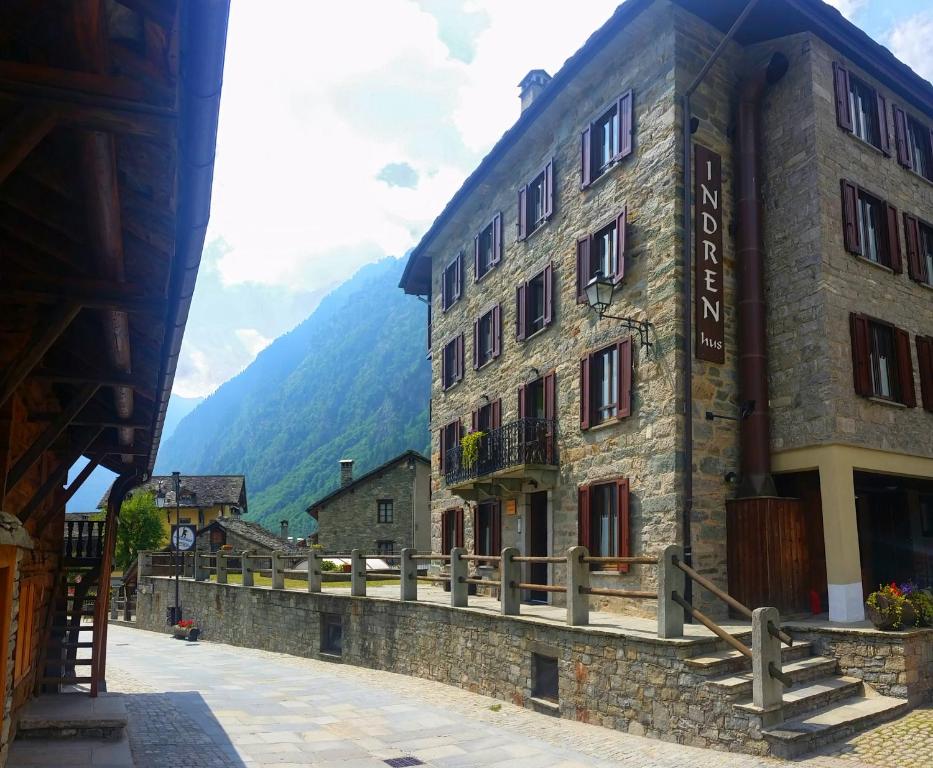 a building on a street with a mountain in the background at Indren Hus in Alagna Valsesia