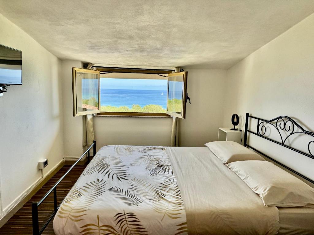 a bedroom with a large bed and a window at Residenza De Vita in Tropea