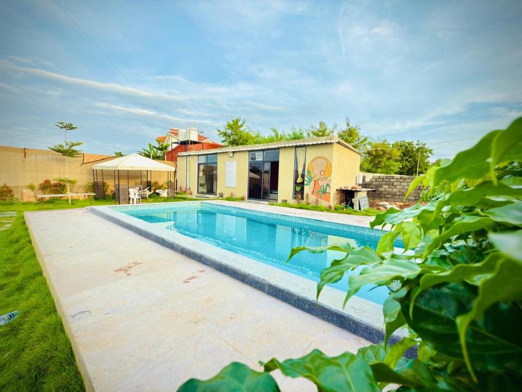 a swimming pool in the backyard of a house at Hosh posh villa in Hyderabad