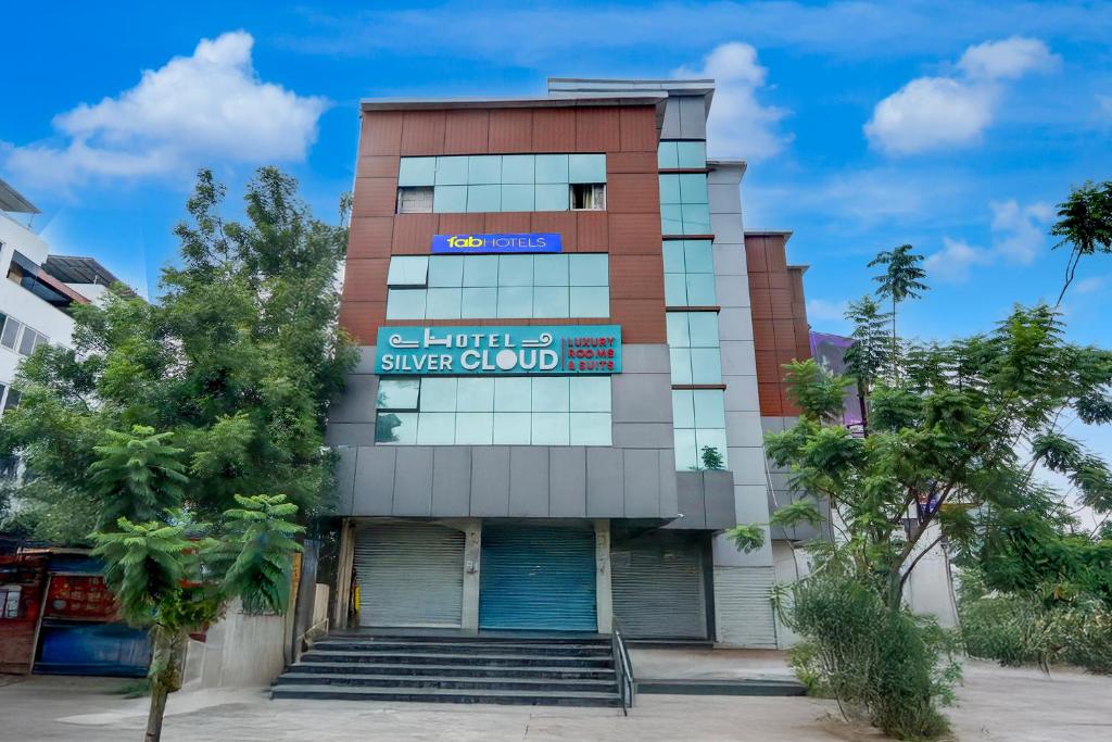 a building with a sign on the front of it at FabHotel Silver Cloud in Warangal