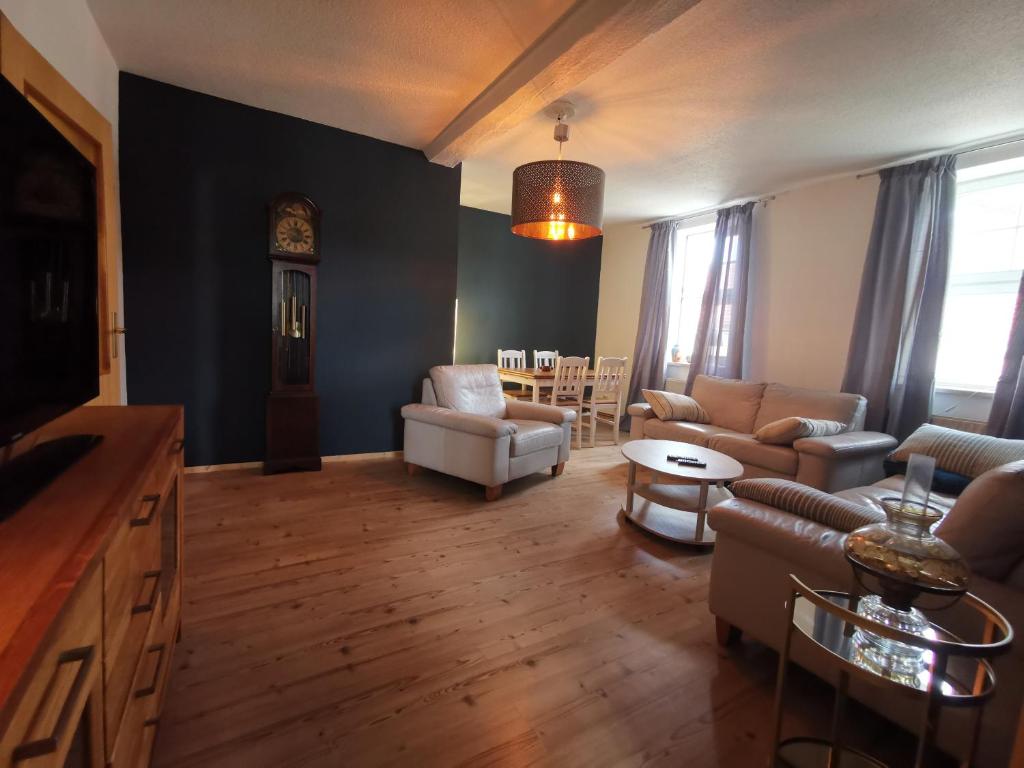 a living room with a couch and a table at Forsthaus Nicolai in Pretzsch