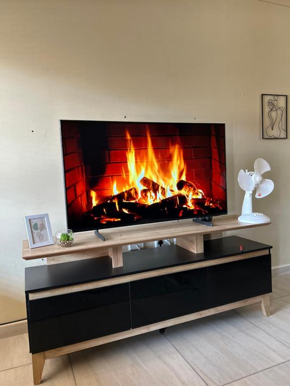 a fireplace in a living room with a fire place at MicasaKollections - Villa Ndahafa in Ongwediva