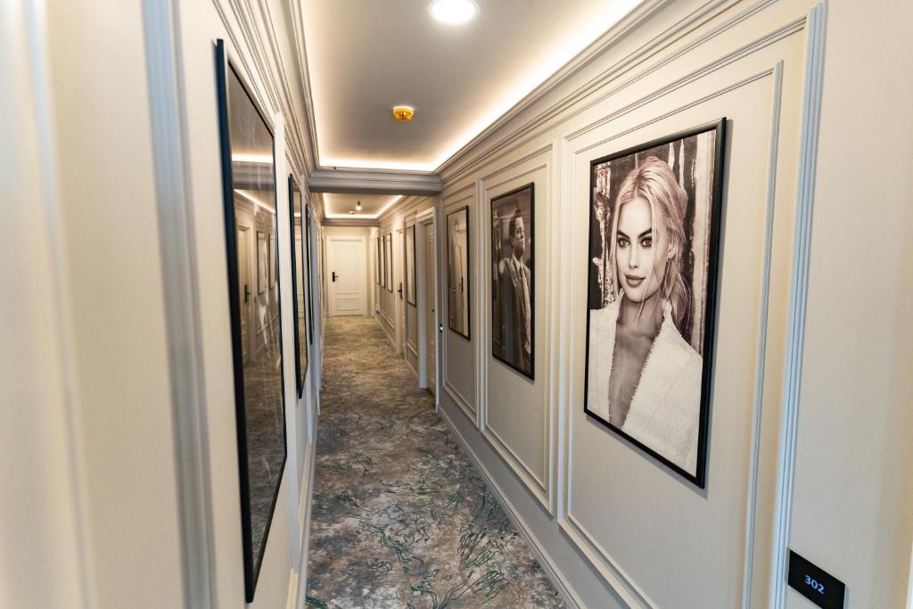 a hallway with framed art on the walls at Cosmopolita Boutique Hotel in Timişoara
