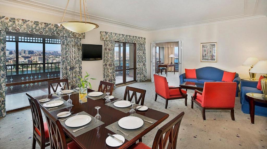 a living room with a table and chairs and a couch at Cairo World Trade Center Hotel & Residences in Cairo