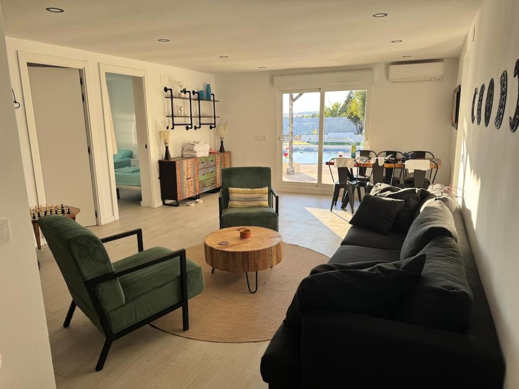 a living room with a couch and chairs and a table at Las Colinas in Illana