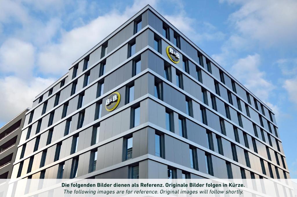 a tall building with a clock on the top of it at B&B HOTEL Lippstadt in Lippstadt