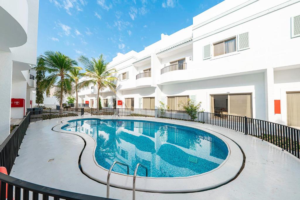 a swimming pool in front of a building at Mabaat-Jasmine Greek Villa 4BR- 583 Villa 11 in Jeddah