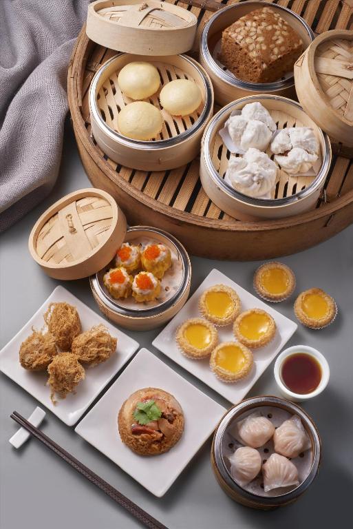 A tabletop spread presents assorted dim sum and Chinese pastries.