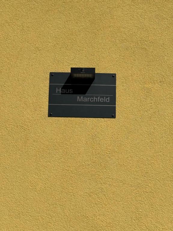 a black sign on the side of a wall at Haus Marchfeld 
