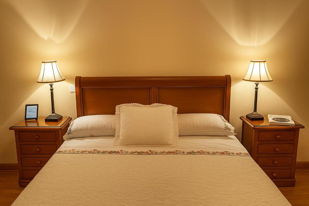 a bedroom with a bed with two lamps on both sides at Lovely 2 bedrooms apartment main square Plasencia in Plasencia