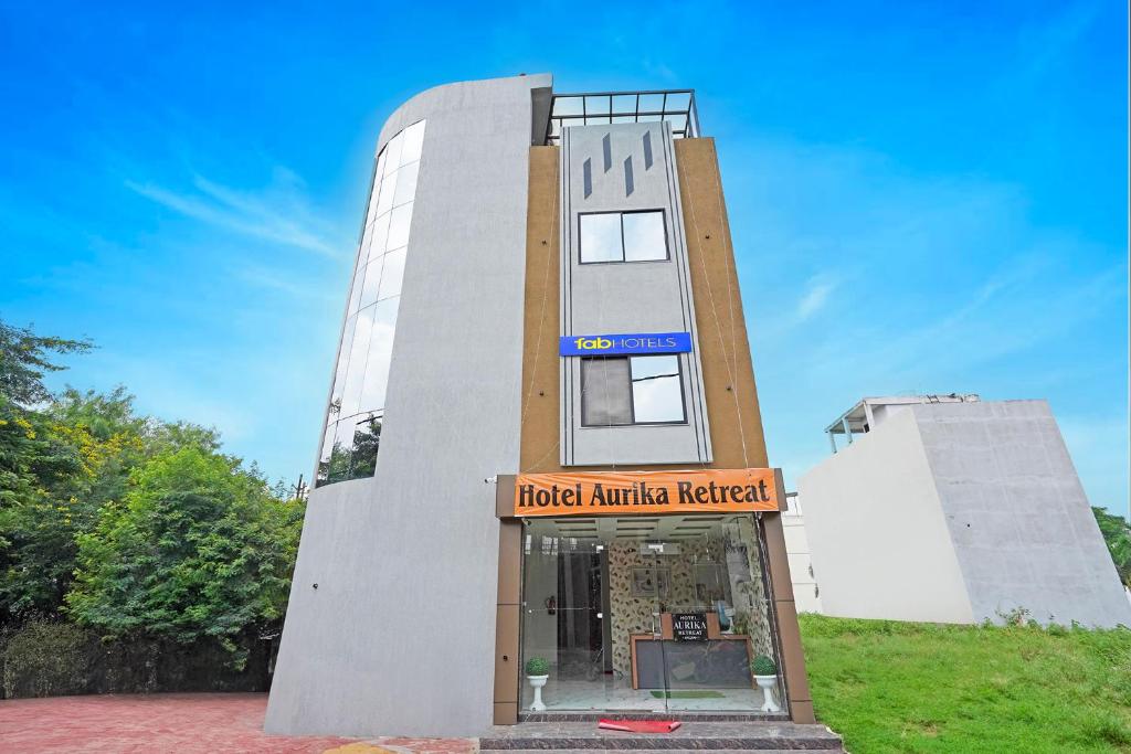 a building with a clock on top of it at FabHotel Aurika Retreat in Indore