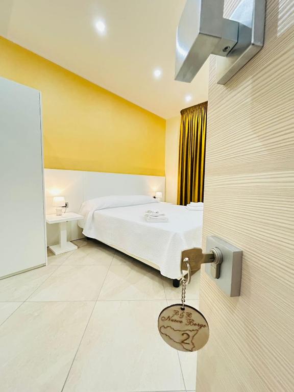 a hotel room with a bed and a key at Nuovo Borgo B&B in Campogrande