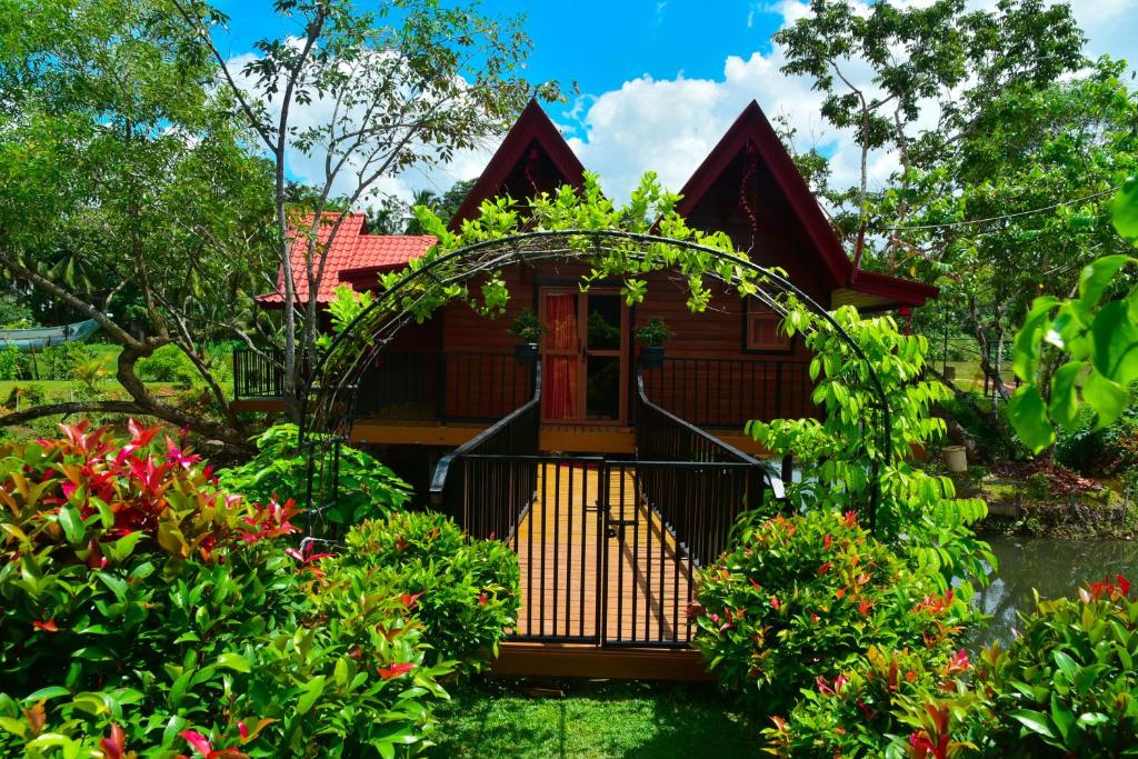 a house with a gate in a garden at Villa I Did in Beruwala