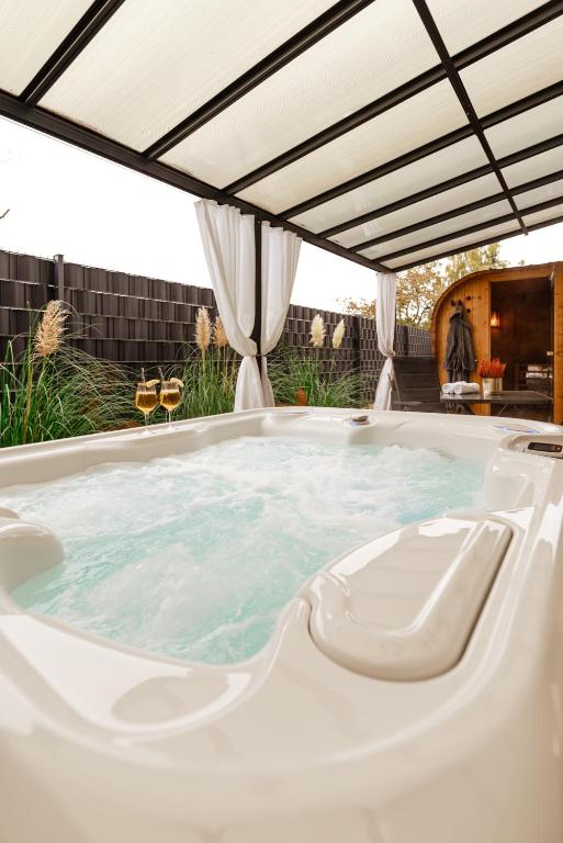 a jacuzzi tub under a pergola at Spa Cottage Serenity Chalet in Rittersdorf