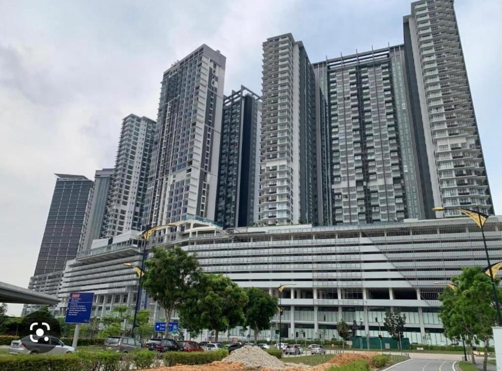 a large building with tall buildings in the background at D'pristine 4 bedroom condo 1725 opposite Legoland and Medini mall in Iskandar Puteri
