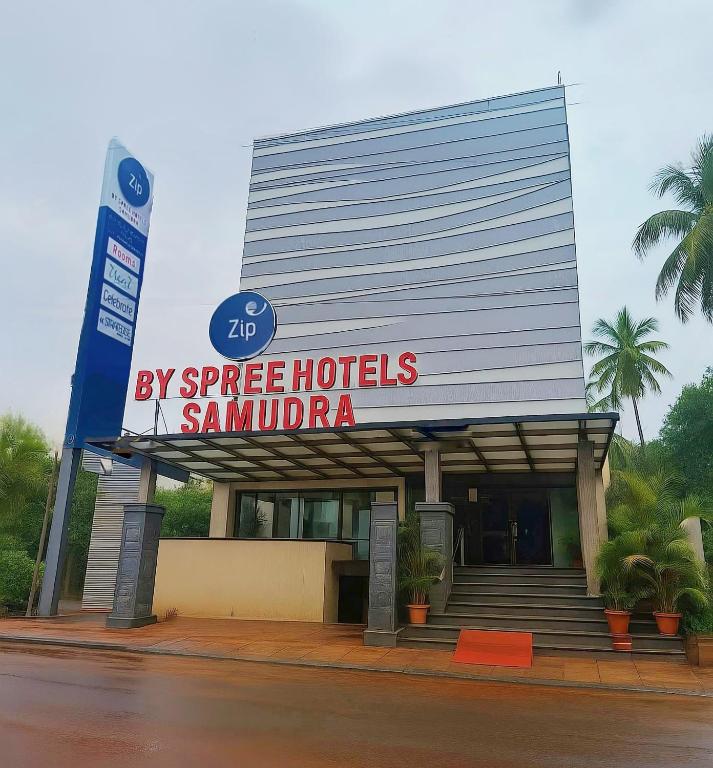 a large building with a hotel sign in front of it at Zip By Spree Hotels Samudra Belgaum in Belgaum