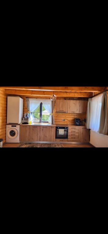 a small kitchen with a stove and a microwave at Cabana La Iura in Bistra