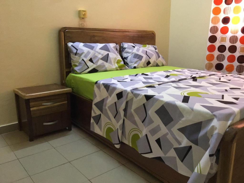 Ένα ή περισσότερα κρεβάτια σε δωμάτιο στο NOOMA PRESTIGE OUAGa 2000