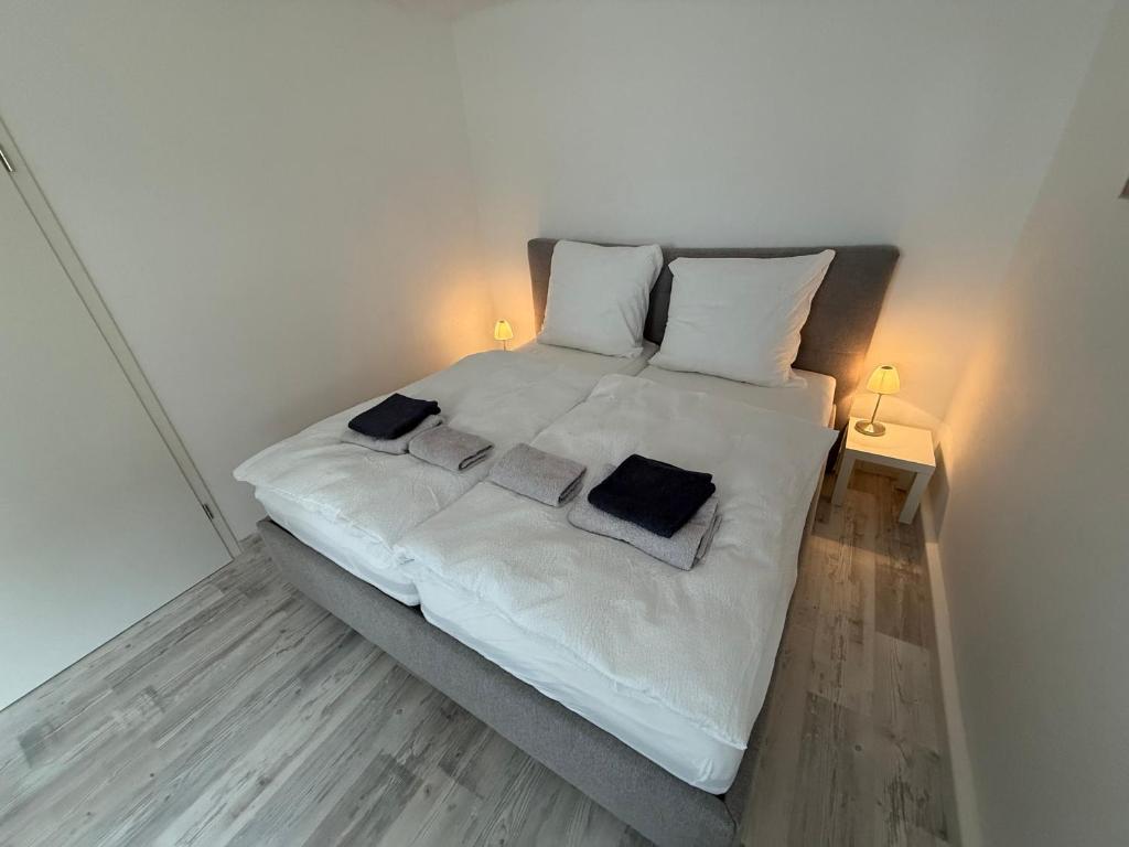 a bedroom with a white bed with two pillows at FEWO FFM str in Kassel