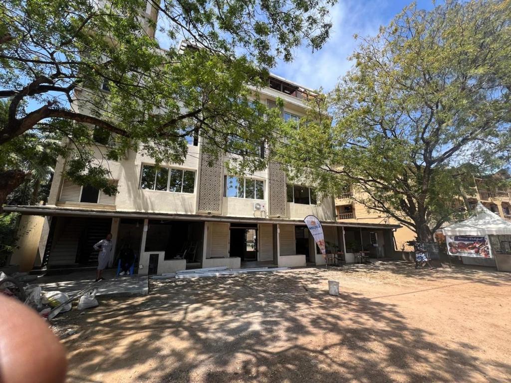 a building with people standing in front of it at holm's home studio in Diani Beach