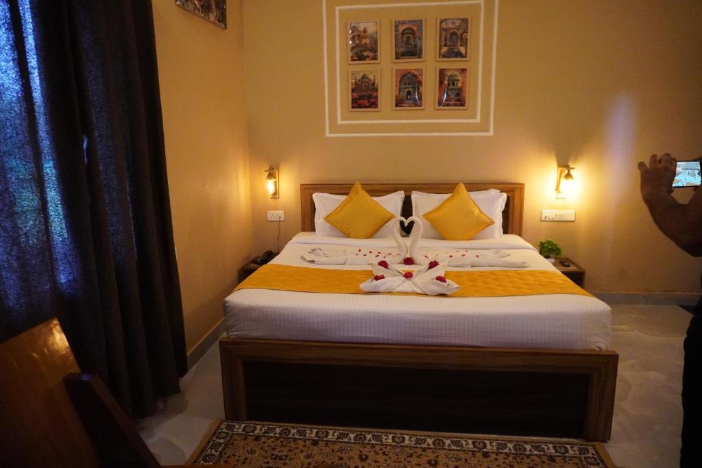 a bedroom with a bed with two bows on it at Bagh mahal by jungle vibes in Sawāi Mādhopur