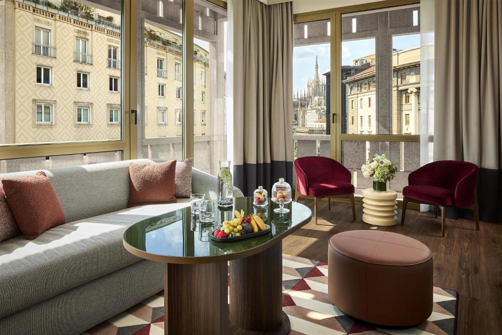 a living room with a couch and a table at Tivoli President Milano Hotel in Milan