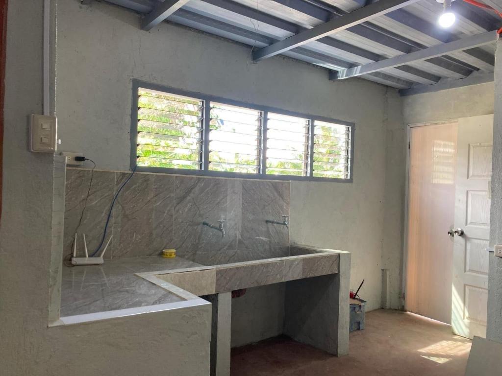 een badkamer met een grote wastafel en een raam bij Puzon-M Bed Space Kidapawan in Kidapawan