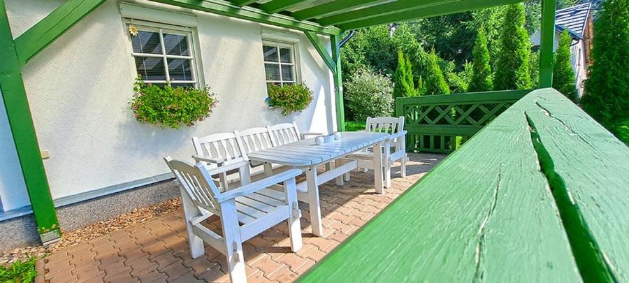 a picnic table and chairs on a patio at Domek Markoušovice in Velké Svatoňovice