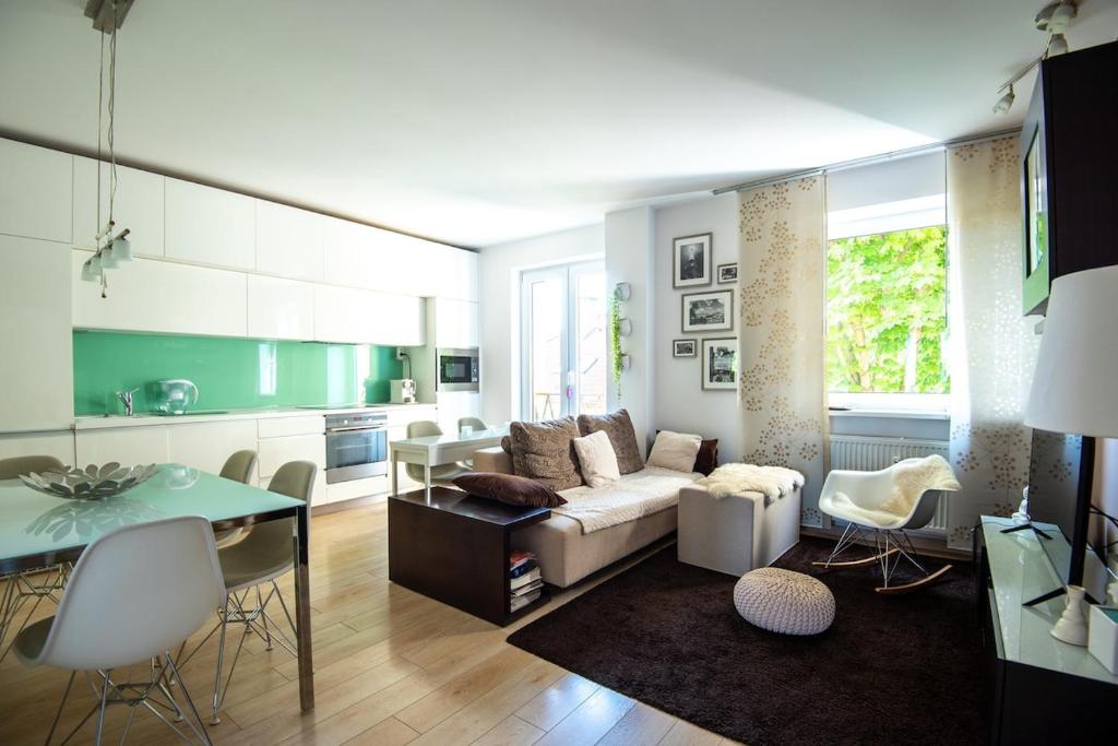 a living room with a couch and a table at Charming 2-BR apartment at Nivy Bratislava in Nivy