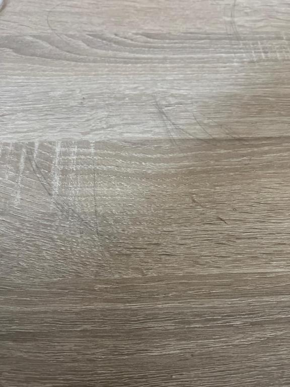 a close up of a wooden floor with scratches at Apartman Zoja in Temerin