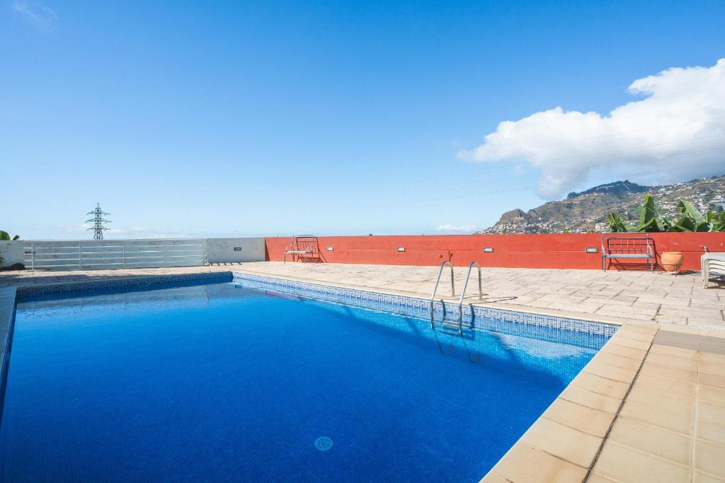 a swimming pool with blue water in front of a building at Pitanga by Atlantic Holiday in Panasqueira