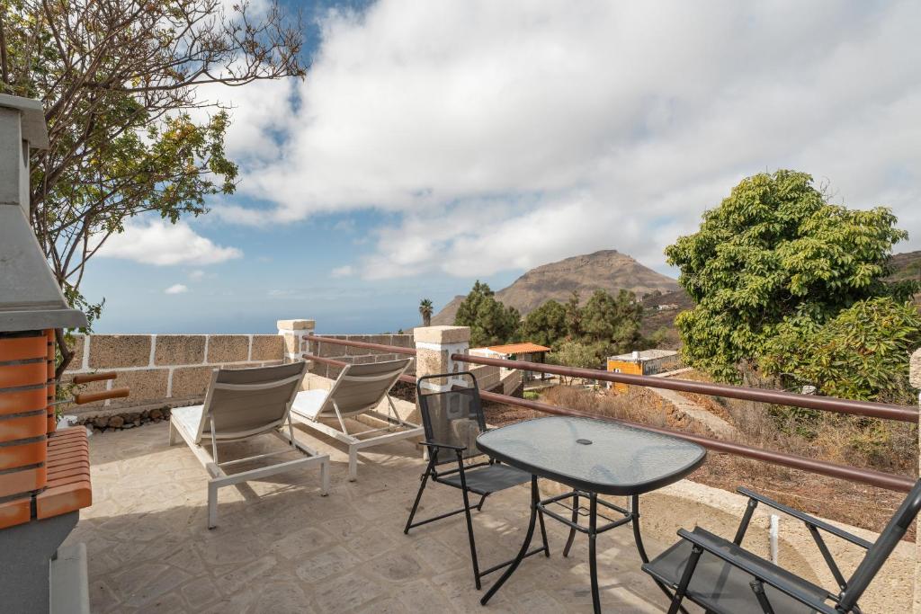 a patio with chairs and a table and a view at La Generosa in Arona