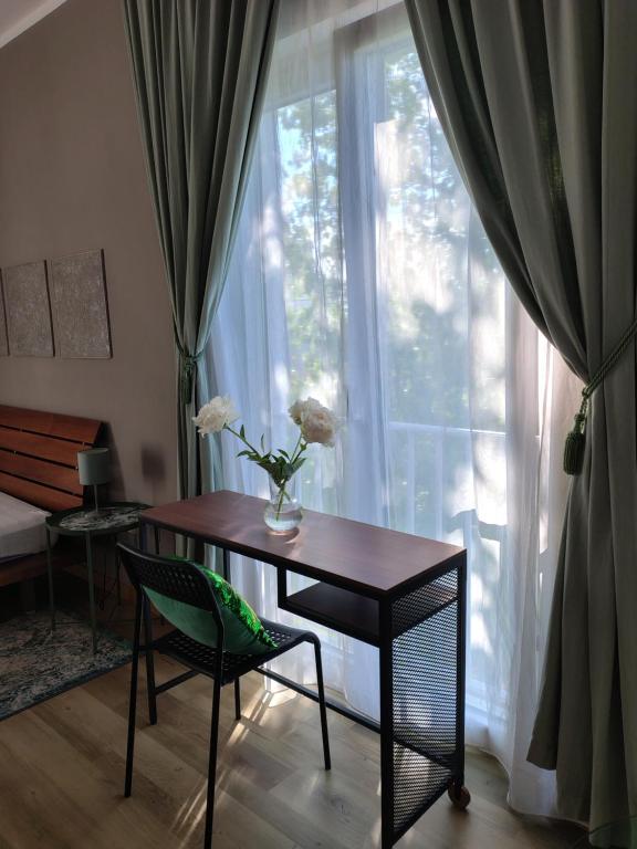 a table and a chair in front of a window at Casa Montefinese1 in Casamassima