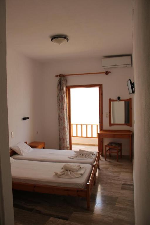 Postel nebo postele na pokoji v ubytování Hotel Alkyon