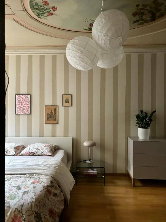 a bedroom with a bed and two white paper lanterns at Bright & Stylish-Heart of Old City-Experienced Hosts in Bern