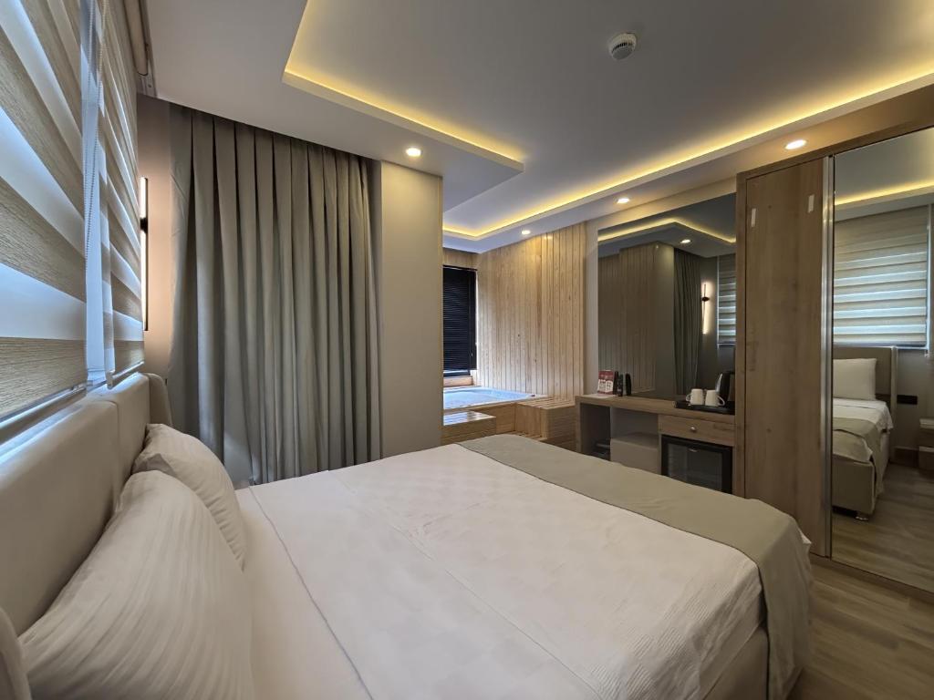 a bedroom with a large white bed in a room at La Vita Es Bella in Antalya