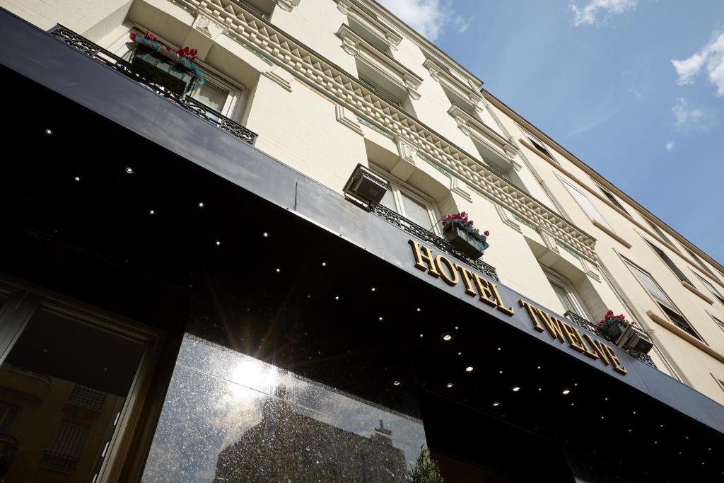 a building with a sign on the front of it at Hotel Le Twelve in Paris
