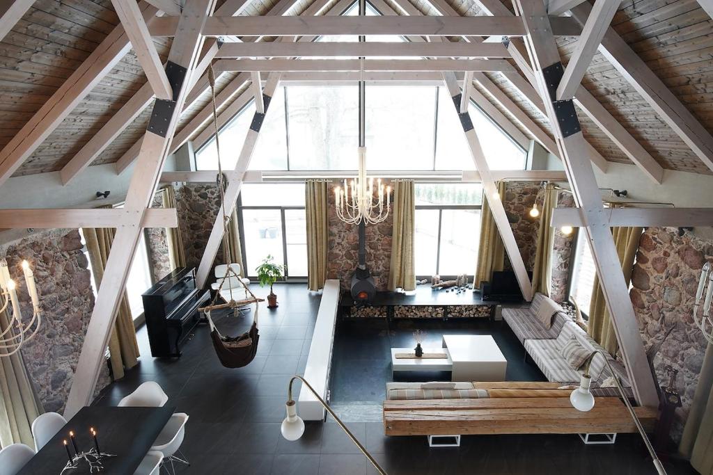 a large living room with a couch and a table at Design stone villa nearby the Baltic sea, 4BR, 5BA in Skulte