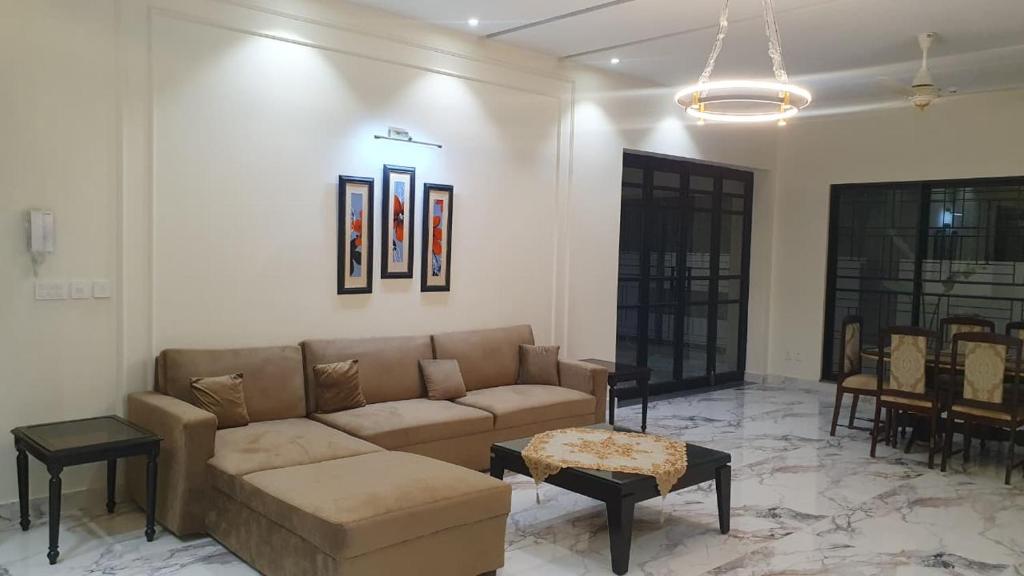 a living room with a couch and a table at 3 bedroom modern house in Lahore