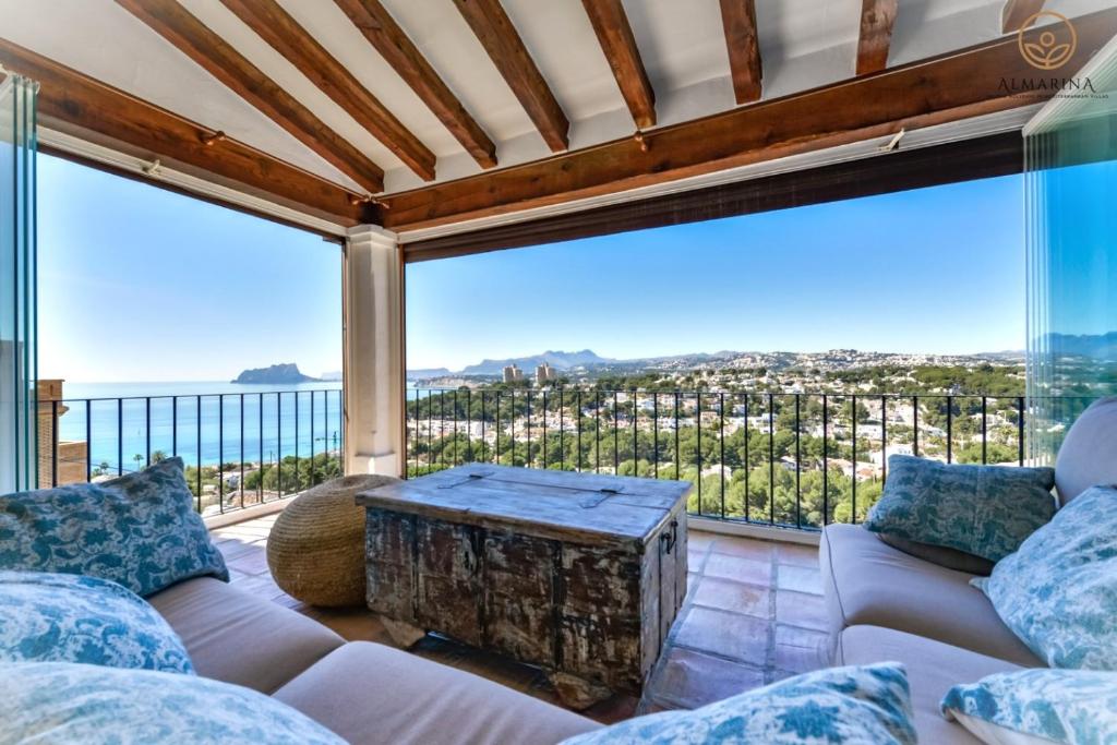 a living room with a couch and a table at BAHÍA DE EL PORTET - By Almarina Villas in Moraira