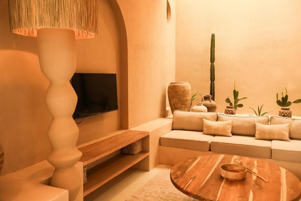 a living room with a couch and a table at Pasir 4 - A stylish 2 bed villa in Bingin w pool in Bingin Beach