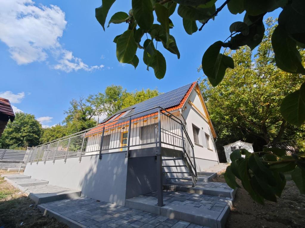 a building with a staircase leading up to it at Dióliget Apartman in Orfű