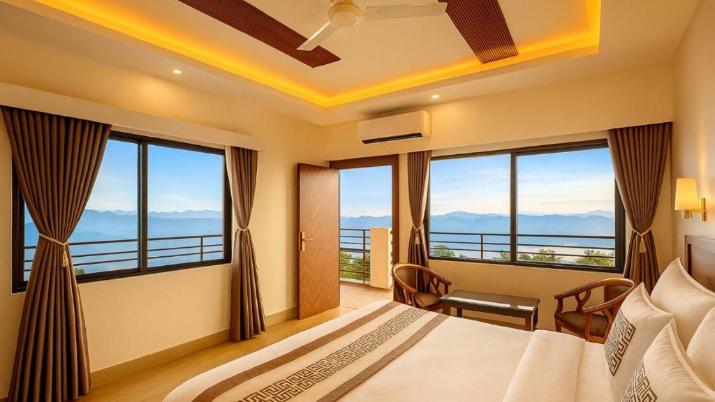 a bedroom with a bed and large windows at Winterline Gold Resort in Lansdowne