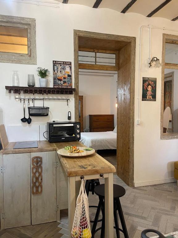 a kitchen with a table with a plate of food on it at Beautiful apartment & garden in Tel Aviv
