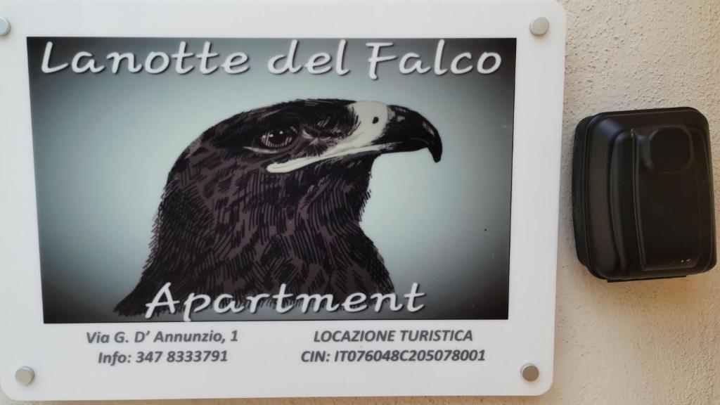 a sign on a wall with a bird on it at Lanotte del Falco in Melfi