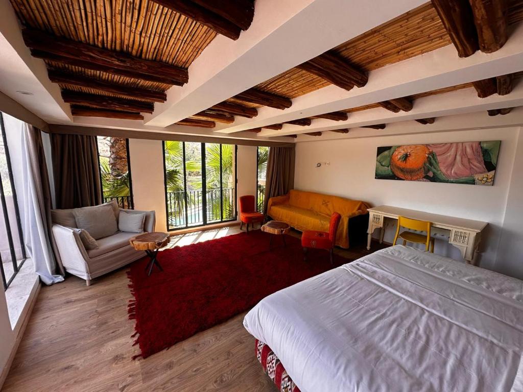 a bedroom with a bed and a couch and a chair at House of Designers 