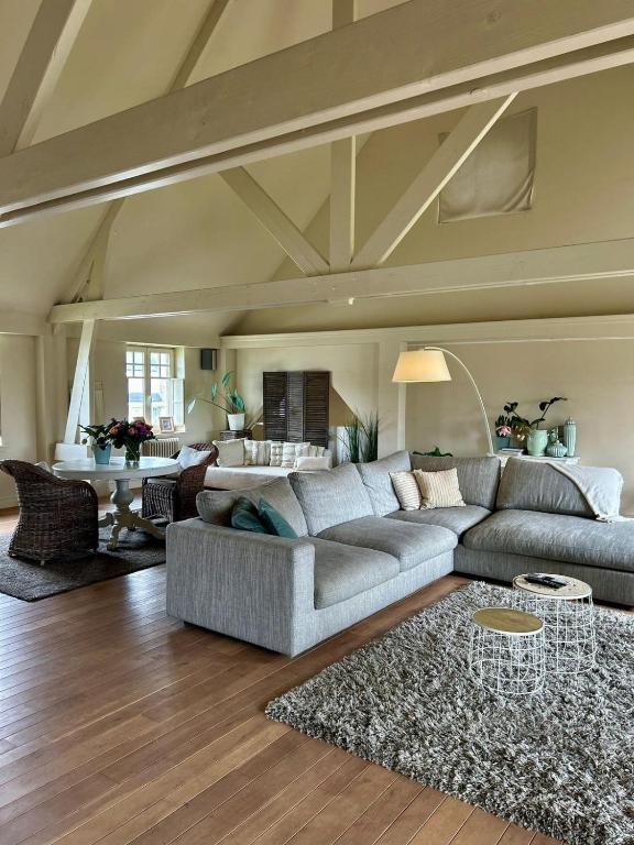 a living room with a couch and a table at De Loft in Melsele