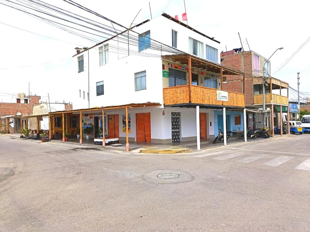 a building on the corner of a street at HOSPEDAJE WELCOME PARACAS peru in Paracas