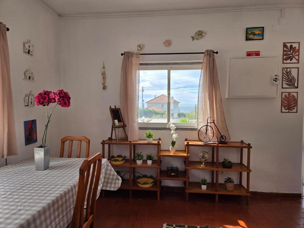 a bedroom with a bed and a window at Casita do avô in Carvoeira