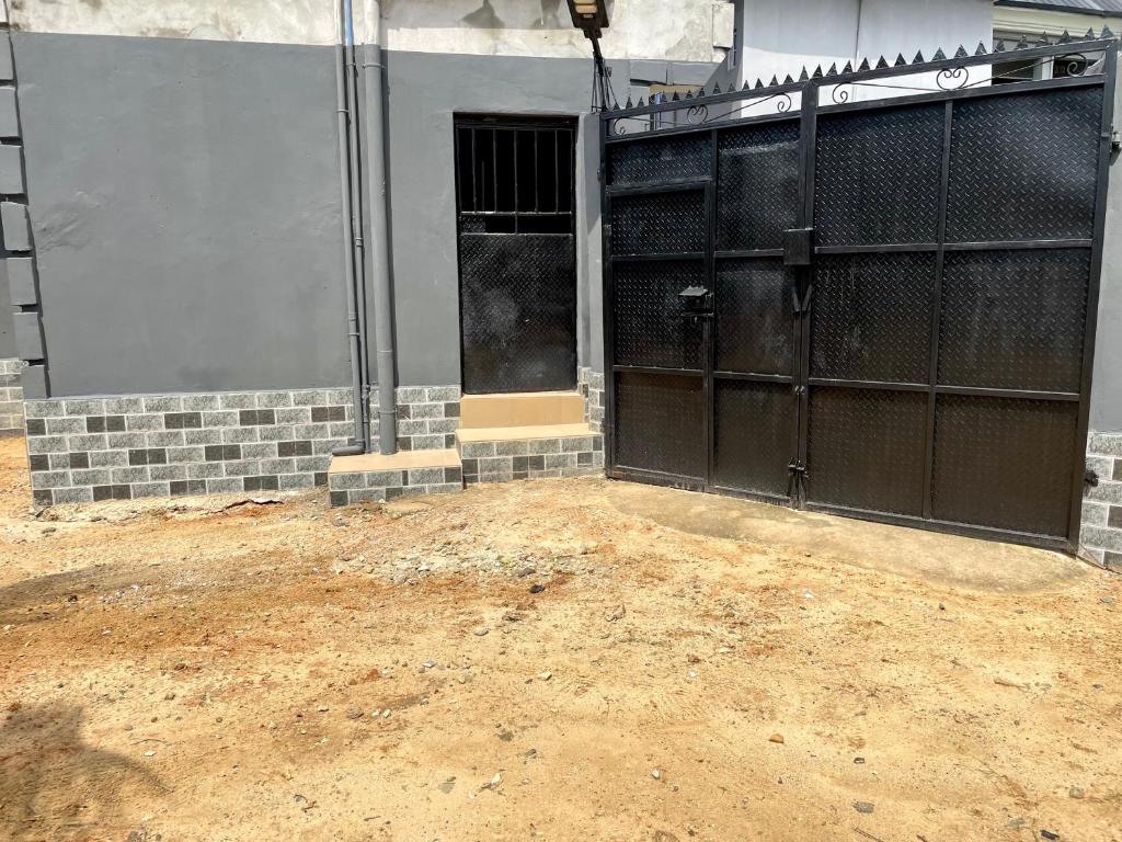 a garage with two sets of doors on a building at Dersym Apartment in Port Harcourt